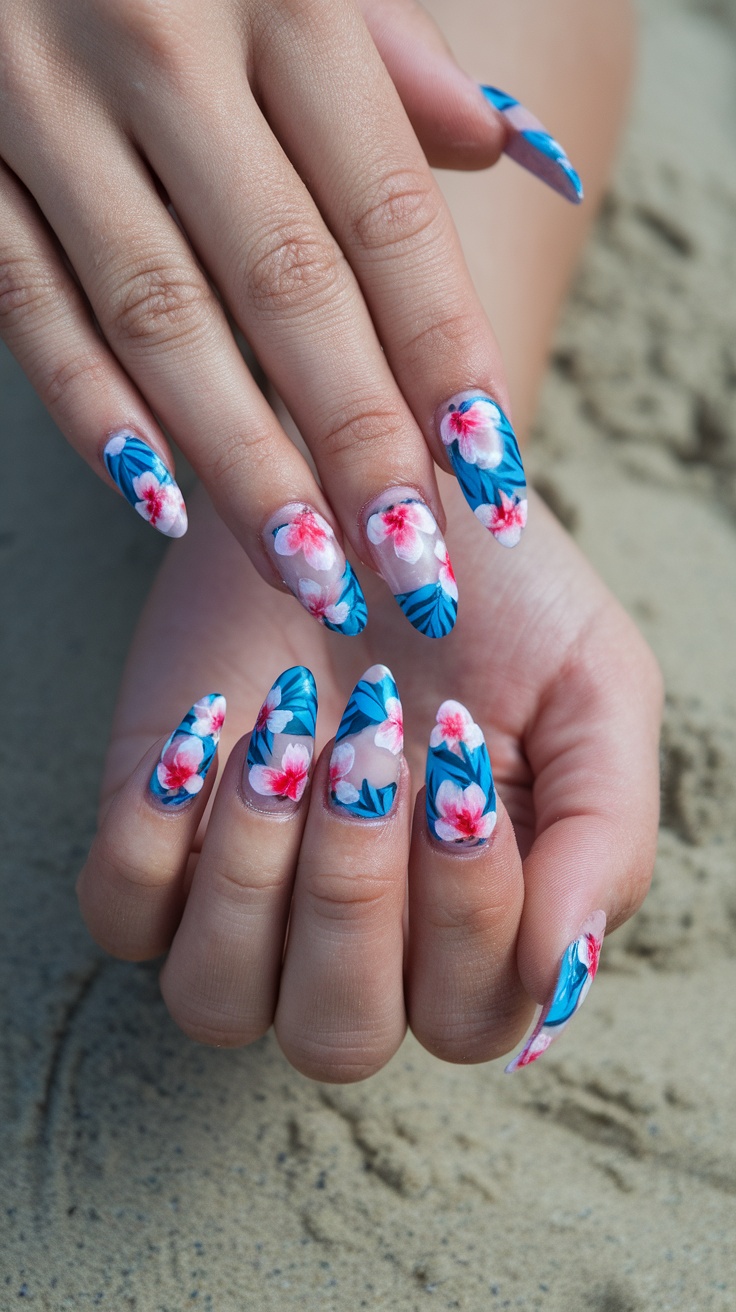 15 Trendy Summer Nail Ideas 3 Nail art featuring floral designs with blue and pink colors on a sandy background
