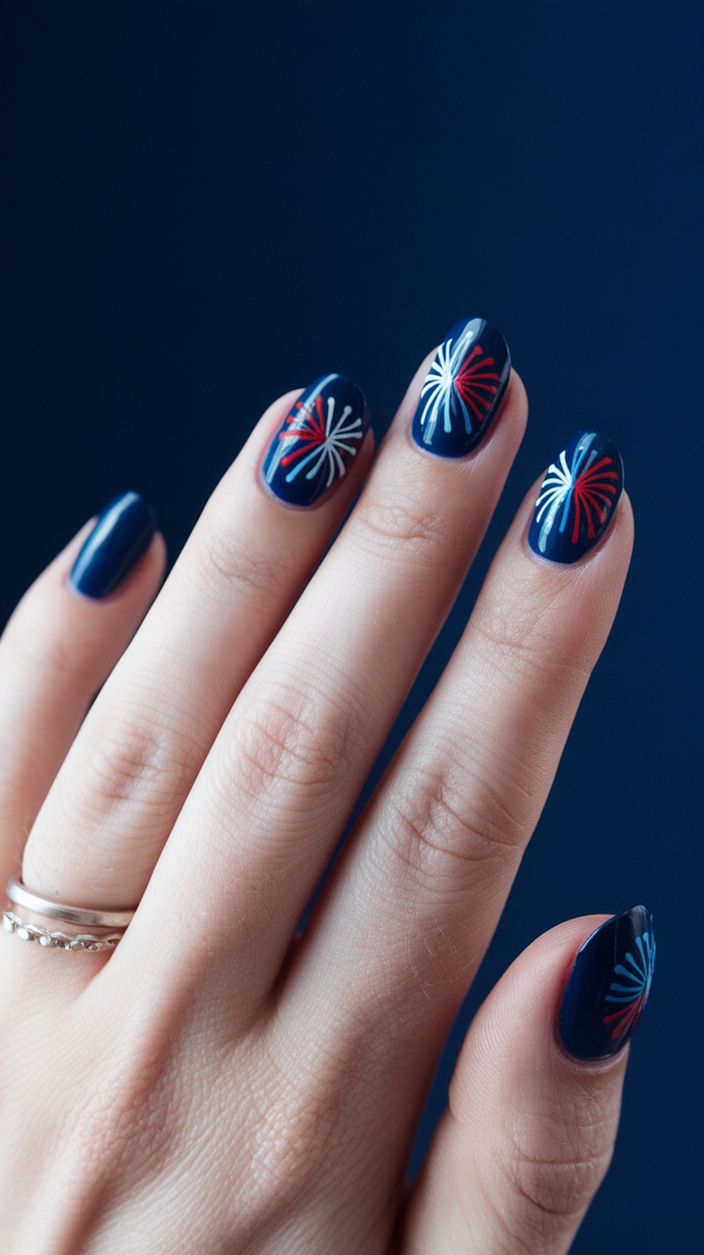 20 Stunning July Nail Designs | Must Try This Summer 7 Nail design featuring fireworks in red and white on a blue background.