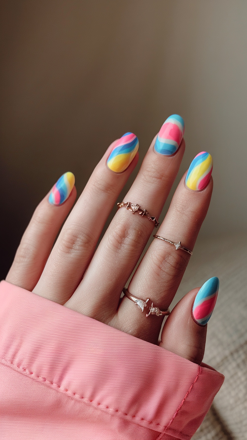 20 Stunning July Nail Designs | Must Try This Summer 13 Colorful tie-dye nails featuring swirls of pink, blue, and yellow, adorned with delicate rings.
